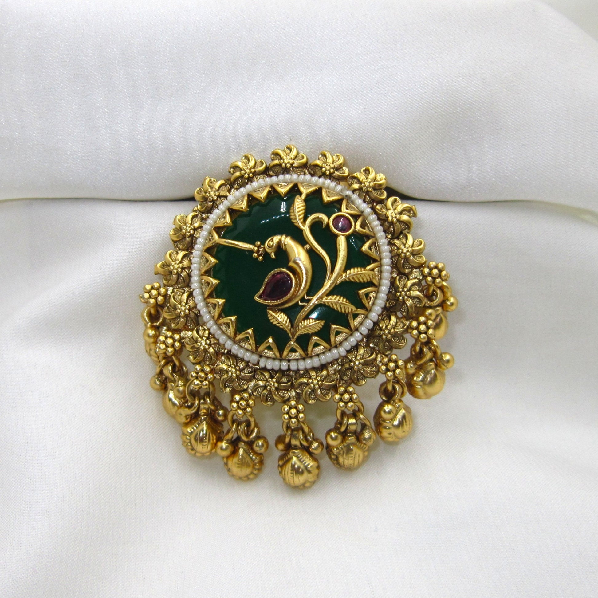 Vanmayuri Heritage Antique Emerald Green Ghungroo Ring by Enava featuring an adjustable antique gold statement ring with emerald green enamel, floral vine design, pearl border and decorative ghungroo charms, perfect for wedding jewellery, festive wear and traditional ethnic outfits.