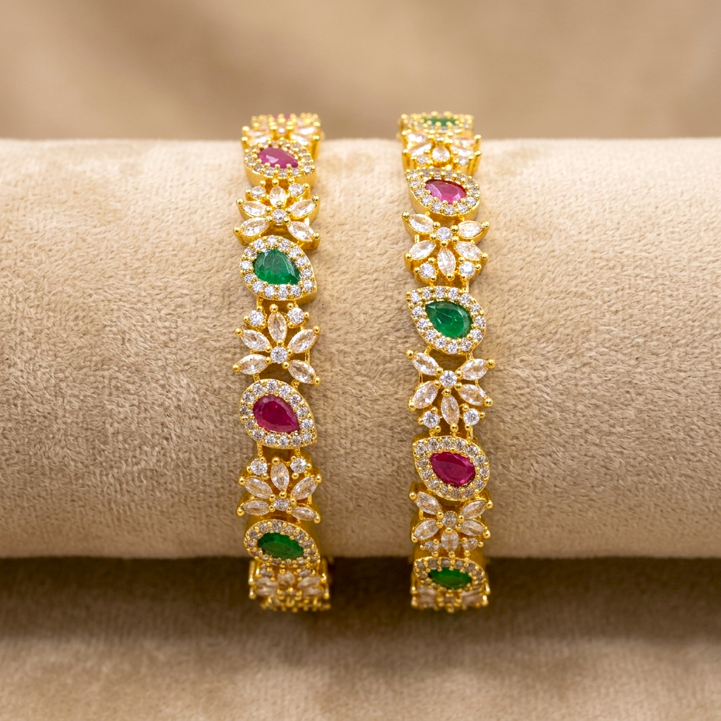 Zirconia Blossom AD Kada Gold Plated Bangles by ENAVA featuring sparkling clear white Cubic Zirconia AD stones in an elegant blossom-inspired design. Premium gold plated bridal kada bangles perfect for weddings, festive occasions, party wear, and ethnic jewellery collections.