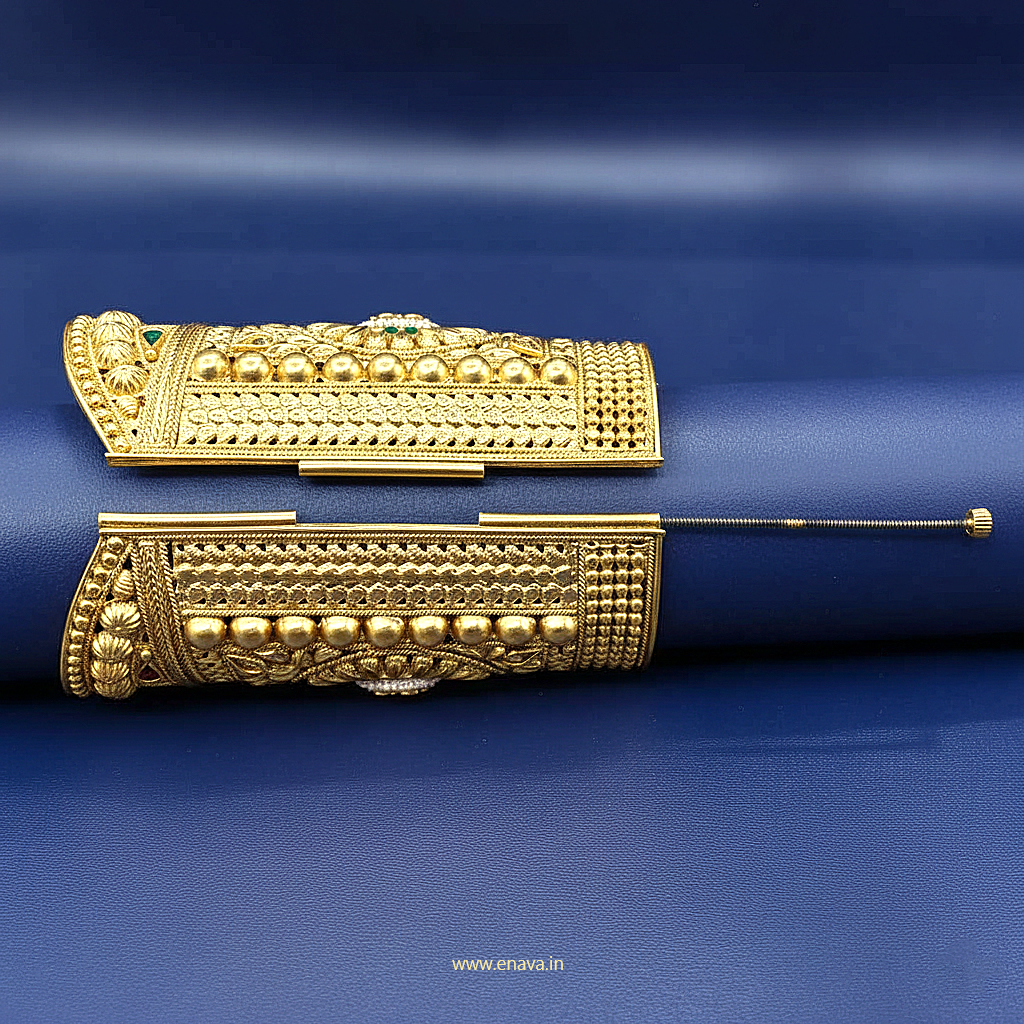 Enava Maharani Rajputana Long Kada, a masterpiece inspired by timeless royal heritage jewelry. Crafted with intricate traditional detailing, this broad Rajwadi kada features elegant floral motifs, antique gold finish, and luxurious handcrafted patterns that reflect the grandeur of Rajputana culture.

Designed for brides, festive occasions, weddings, and royal ethnic styling, this statement kada beautifully complements lehengas, sarees, and traditional outfits. Its bold long-cuff design adds a majestic touch