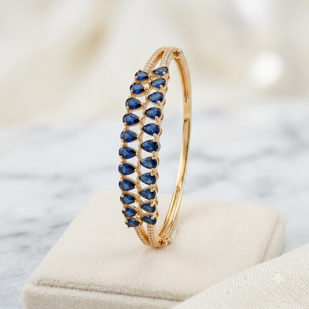 Blue Stones AD Bracelet with a series of deep blue American Diamond stones, sparkling AD detailing and gold-tone finish, elegant designer bracelet for women by ENAVA.